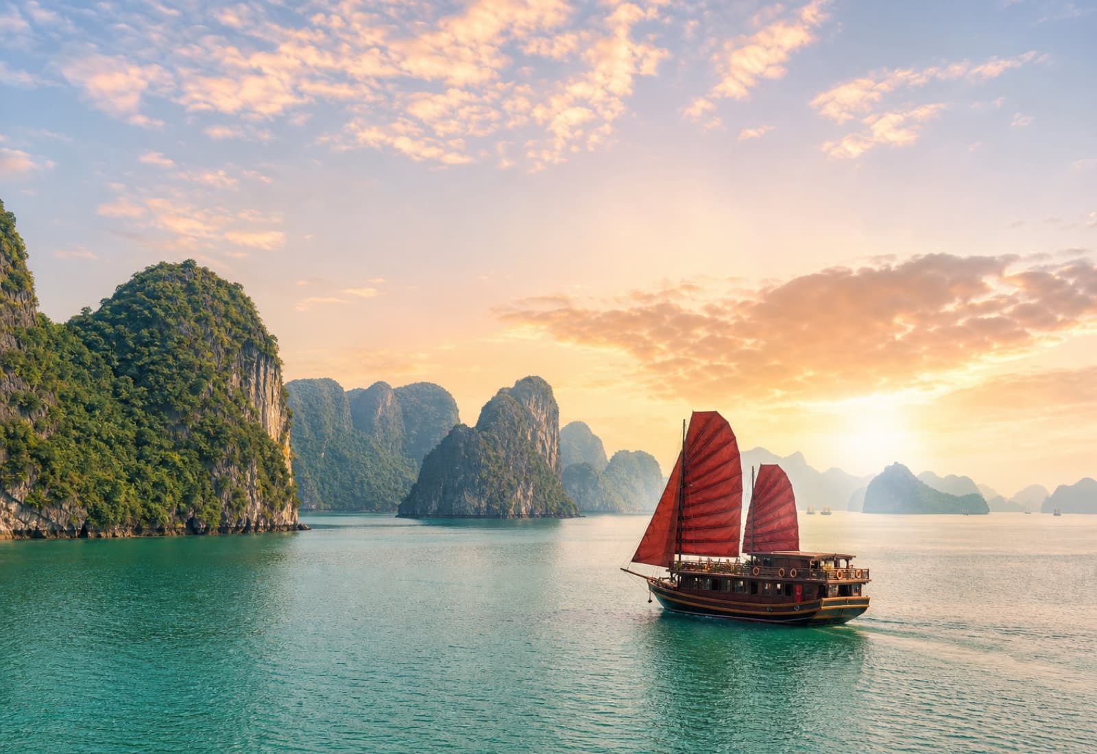 Traditional cruise boat sailing through Ha Long Bay